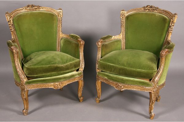 PR VINTAGE FRENCH LOUIS XV STYLE BERGERES CHAIRS: Pair of vintage French Louis XV style giltwood and carved bergeres with downswept arms, loose cushion seats and shaped legs circa 1920. Ensuite with the following lot. Ht: 37" Width: 28" Depth: 18" **