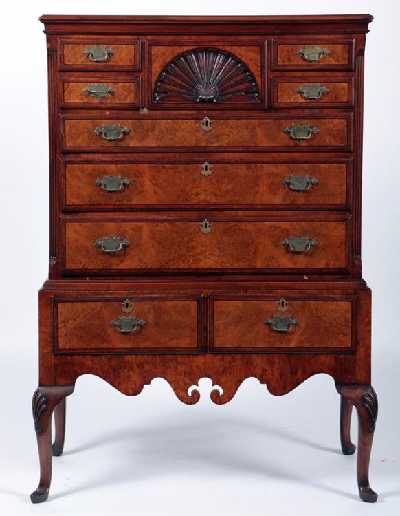 BURLED WALNUT CARVED HIGHBOY BY SMITH & WATSON: A burled walnut fan carved highboy by Smith and Watson. Ht: 55.5" Width: 39.25" Depth: 21.5"