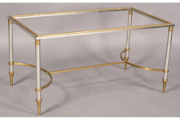 CLASSIC STYLE CHROME BRASS GLASS COFFEE TABLE: Classical style chrome and brass coffee table with inset glass top, brass frame, turned legs with brass mounts and shaped stretcher circa 1960. Ensuite with the following lot. Ht: 18.5" Width: 36" Dep