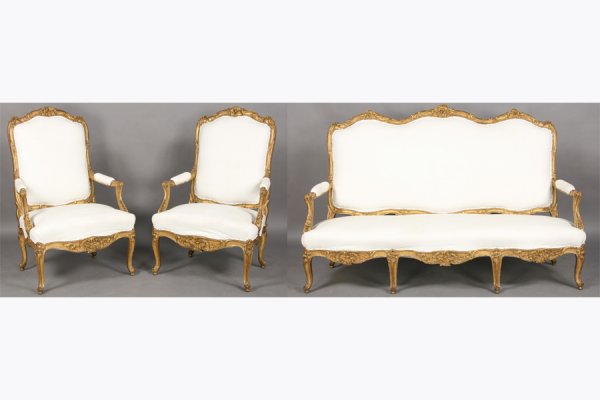 SALON SET ANTIQUE FRENCH REGENCE STYLE LARGE: Antique French Regence style overscaled giltwood salon set consisting of a pair of shaped fauteuils and a settee with serpentine back circa 1860. All with upholstered backs and seats, the chairs with 