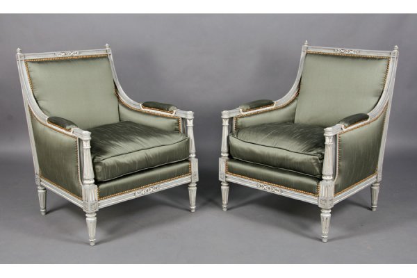 PR FRENCH LOUIS XVI STYLE CARVED BERGERES: Pair of French Louis XVI style carved and painted bergeres having square backs with turned finials and fluted and tapered legs circa 1940. Downswept arms with fluted columns and loose cushion seats. H