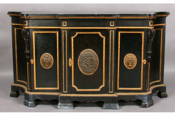 ANTIQUE NAPOLEONIC STYLE EBONIZED BRONZE CREDENZA: A Napoleonic style ebonized and bronze-mounted credenza with stepped and shaped top over three drawers and stepped bracket feet circa 1880. Each drawer with central bronze figural medallion framed by