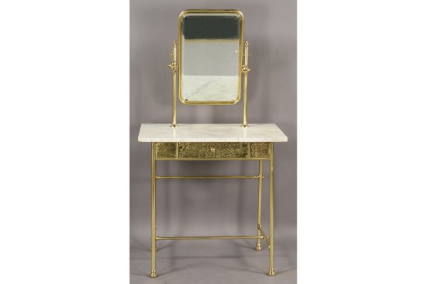 VICTORIAN STYLE VANITY BRASS MARBLE: Victorian style dressing table with central beveled mirror flanked by candle holders over a marble topped single-drawer base circa 1920. Having hand-hammered brass sides and round legs with H-stretche