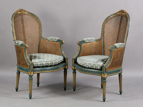 PAIR aNTIQUE FRENCH PAINTED GILT CANE CHAIRS: Pair of French painted, gilt, and caned chairs circa 1900. Dimensions: Ht: 41" Width: 25" Depth: 25".