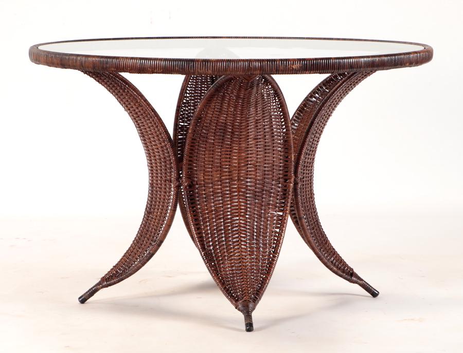 UNUSUAL WICKER IRON GLASS TOP TABLE CIRCA 1960: An unusual wicker and iron glass top table circa 1960. Ht: 30" Wd: 45"