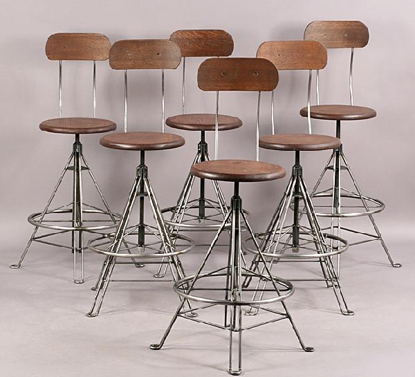 SET 6 INDUSTRIAL STOOLS WOOD METAL EIFEL TOWER: A set of six stylish industrial stools with wood backs and seats supported on metal and rotating Eiffel Tower inspired base. Ht: 45" Diameter: 18"