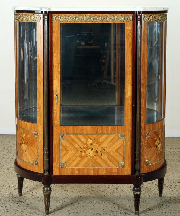 LOUIS XVI STYLE TULIP WOOD CHINA CABINET C.1945: A Louis XVI style tulip wood and marquetry inlaid china cabinet circa 1945. The case having curved glass sides, bronze mounts and glass shelves. Ht: 66" Wd: 53.25" Dpth: 18"