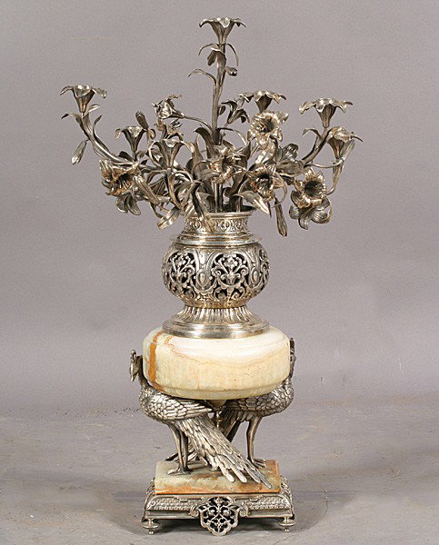 IMPORTANT CHRISTOFLE ANTIQUE BRONZE CENTER PIECE: Important Christofle silvered bronze center piece having back to back creatures supporting the onyx standard below a pot of flowers circa 1890. Ht: 31" Terms & Conditions: PLEASE NOTE: All property sh