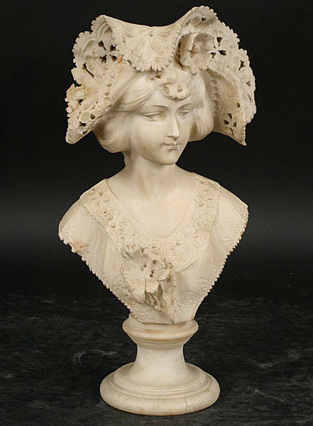 SIGNED CARVED ALABASTER BUST WOMAN: A signed carved alabaster bust of a woman wearing a chapeau resting on a circular plinth signed indistinctly en verso circa 1900. Ht: 20.5" Width: 11" Depth: 6" Terms & Conditions: PLEASE NOTE: All pr