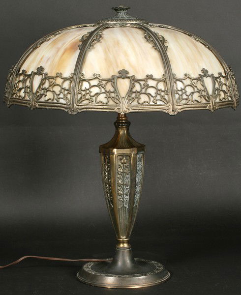 VINTAGE TABLE LAMP DOMED SLAG GLASS C. 1930: A vintage table lamp with domed slag glass shade with pierced decoration over an ornate base circa 1930. Possibly Pittsburgh Lamp Company. Ht: 25" Width: 20.5" Terms & Conditions: PLEASE NOTE: All pro