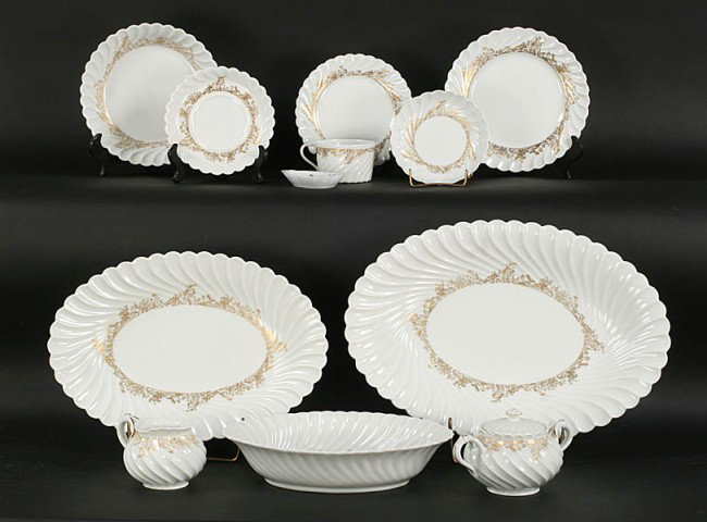 HAVILAND LIMOGES DINNER SERVICE LADORE PATTERN: Haviland Limoges porcelain dinner service in the "Ladore" pattern having shaped edges and gilt decoration comprising eighty-four pieces. Set includes 10.5-inch dinner plates, three serving dishes and 