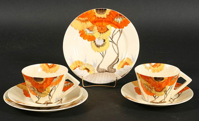TWO CLARICE CLIFF MATCHING TABLE SETTING TEA CUPS: Two Clarice Cliff matching table settings comprising conical shape cups, saucers and plates hand painted with the Rhodanthe pattern. Ht: Width: Depth: