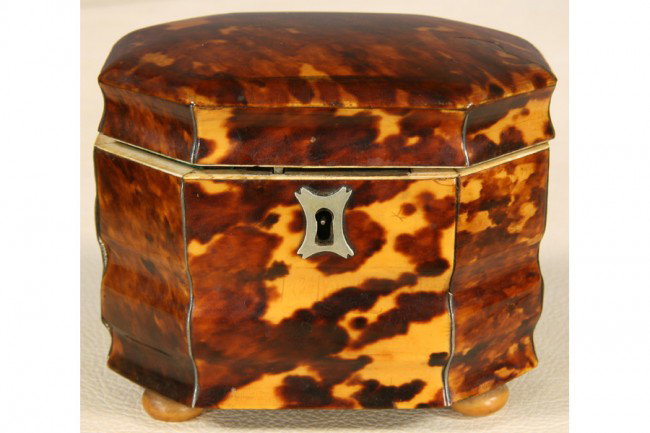 ANTIQUE TORTOISE SHELL SILVER BOX TEA CANISTER: Antique tortoise shell and ivory octagonal tea canister with silver escutcheon, lidded interior and bun feet circa 1800. Ht: 3.75" Width: 4.75" Depth: 3.25"