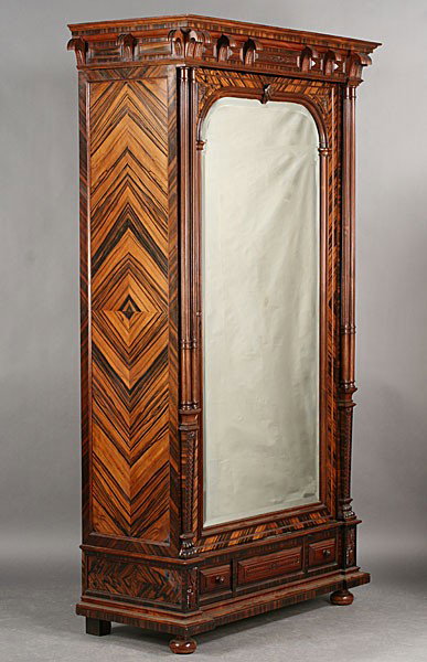 ANTIQUE FRENCH MACCASSAR ARMOIR MIRROR DOOR: Antique French macassar armoire having a carved cornice over a beveled mirror door flanked by fluted columns circa 1880. The whole over a single drawer and raised on ball feet. Ht: 88" Width: 47" Dept