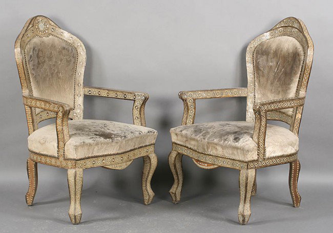PR ANTIQUE SYRIAN INLAID ARM CHAIRS C.1920: Pair of fine antique upholstered Syrian arm chairs having elaborately inlaid arched frames, shaped arms and cabriole legs circa 1920. Ht: 43.5" Width: 27" Depth: 24"