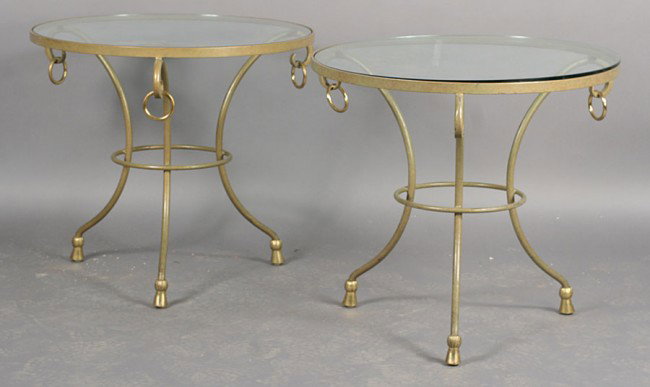 PAIR EMPIRE WROUGHT IRON GUEIRDONS GLASS TOPS: A pair of Empire style wrought iron gueirdons with glass tops supported on downswept legs with ring and tassel decoration. Ht: 27" Diameter: 30"