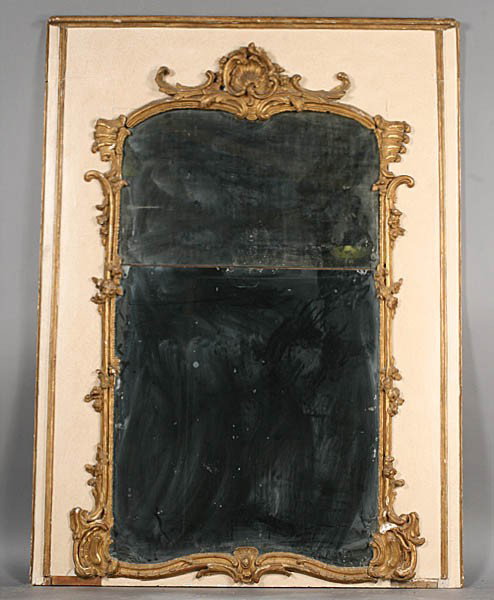ANTIQUE FRENCH TRUMEAU MIRROR ORNATE FRAME: Antique French trumeau mirror having an ornate giltwood carved and painted frame surrounding the two sections. Early nineteenth century. Ht: 69" Width: 52.5"