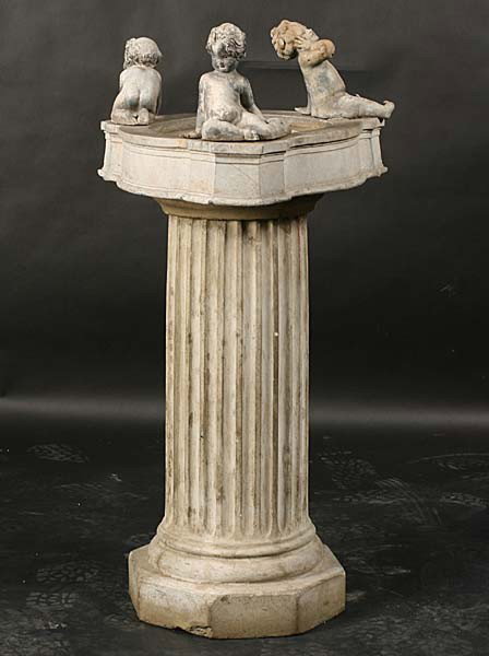 VINTAGE FRENCH LEAD FIGURAL BIRD BATH SHALLOW: A very good vintage French lead figural bird bath having three playful putti mounted around shallow bowl circa 1930. Supported on cast stone fluted column. Ht: 39" Width: 18" Depth: 18"