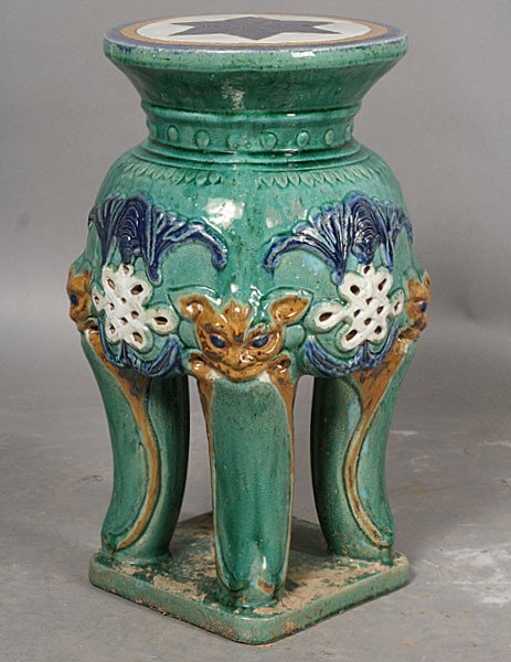 CERAMIC GARDEN STOOL GLAZED PAINTED FACES: Glazed ceramic garden stool having painted faces above each leg. Ht: 21" Width: 14"