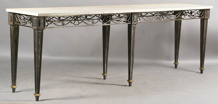 FINE FRENCH FER FORGE CONSOLE TABLE MARBLE TOP: A very fine French Fer Forge console table in the Raymond Subes style with marble top over open work apron circa 1920. Supported on six hand hammered tapered legs with bronze sabots. Ht: 34" Width: 10