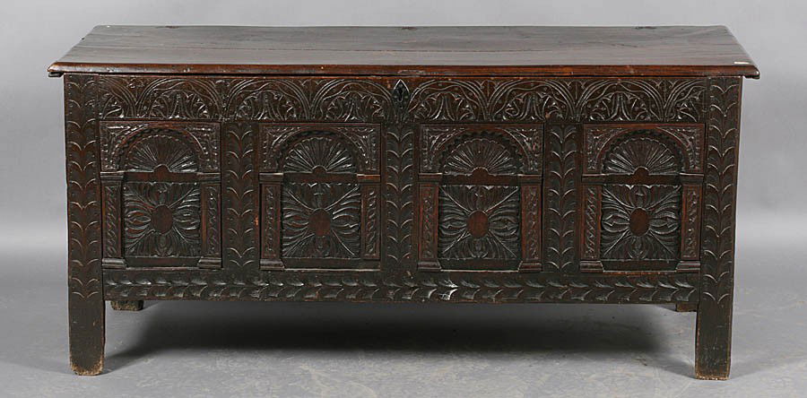 ENGLISH ANTIQUE 17TH CEN STYLE CARVED WOOD CHEST: English antique seventeenth century style carved wood chest having elaborately carved front panel, raised on legs. Ht: 26.5" Width: 37.5" Depth: 21"