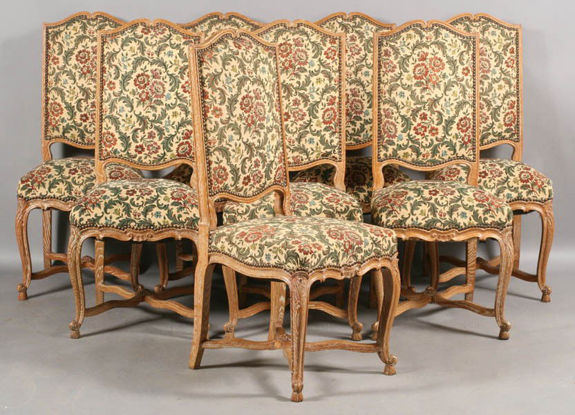 SET 8 FRENCH MID CENT CERUSED OAK DINING CHAIRS: A set of eight French cerused oak dining chairs having upholstered backs and seats over cabriole legs with shaped X-form stretchers circa 1950. Ht: 41.5" Width: 18.5" Depth: 18"