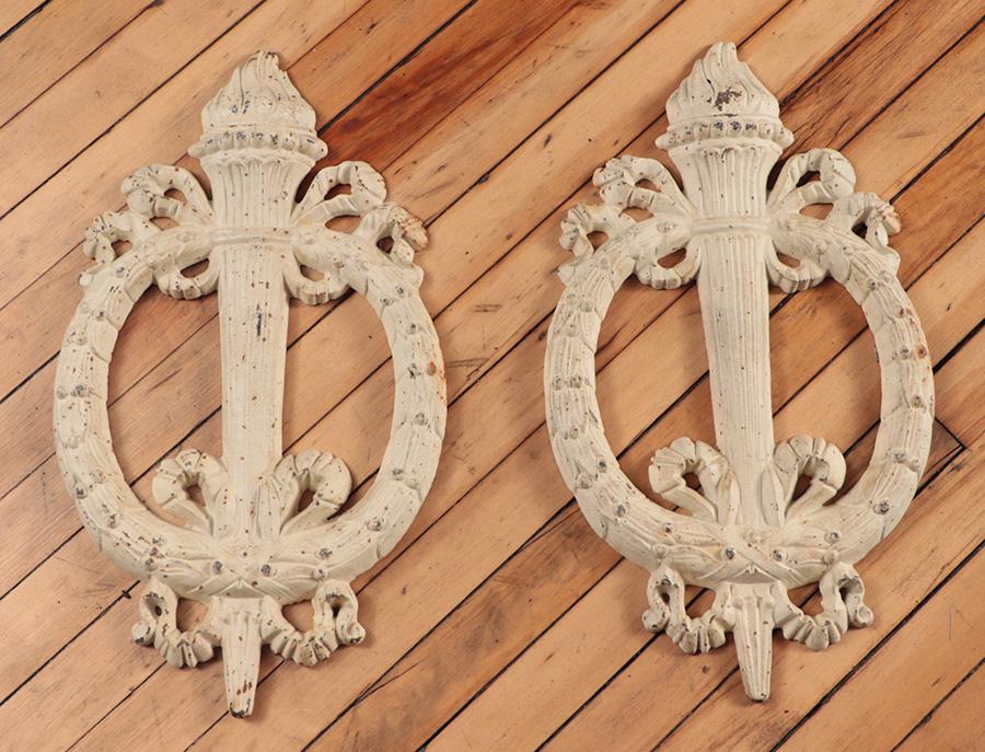 A PAIR OF CAST IRON WREATHS WITH TORCHES.: A pair of cast iron wreaths with torches. Ht: 20" Wd: 11.5"