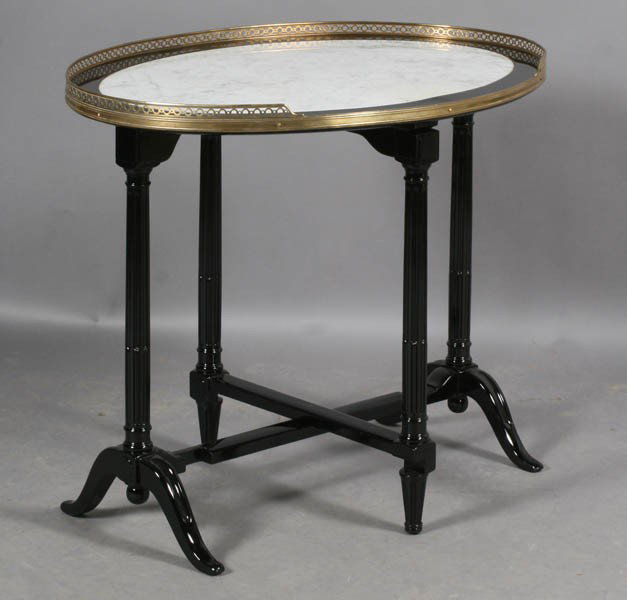 REGENCY STYLE EBONIZED TILT TOP TABLE ATT. JANSEN: A Regency style ebonized tilt top table attributed to Jansen having an inset marble top and bronze pierce work gallery circa 1940. Supported on stop fluted legs. Ht: 29" Width: 34" Depth: 26"
