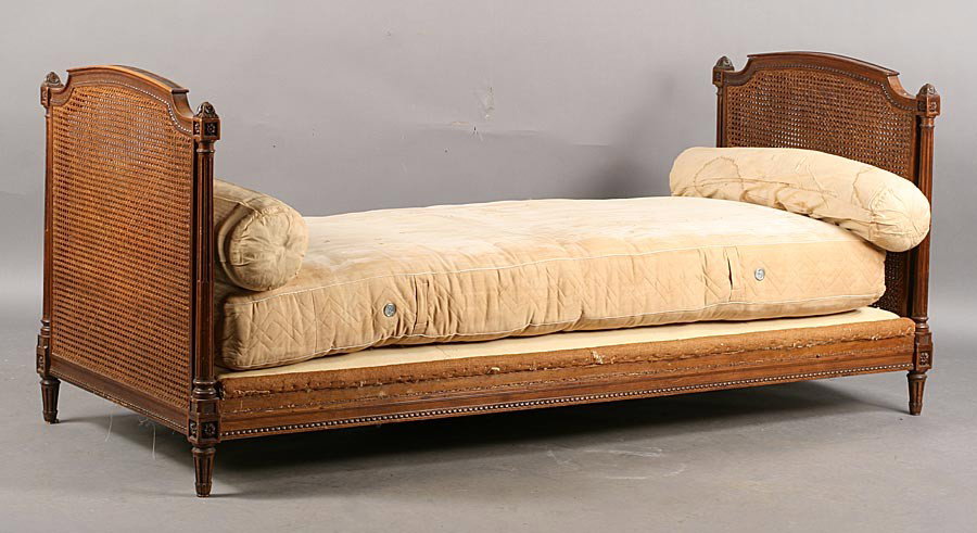 FRENCH LOUIS XVI STYLE VINTAGE WALNUT DAYBED: French Louis XVI style daybed having double caned and carved walnut ends with open stop fluted columns circa 1940. Ht: 34" Width: 80" Depth: 34"