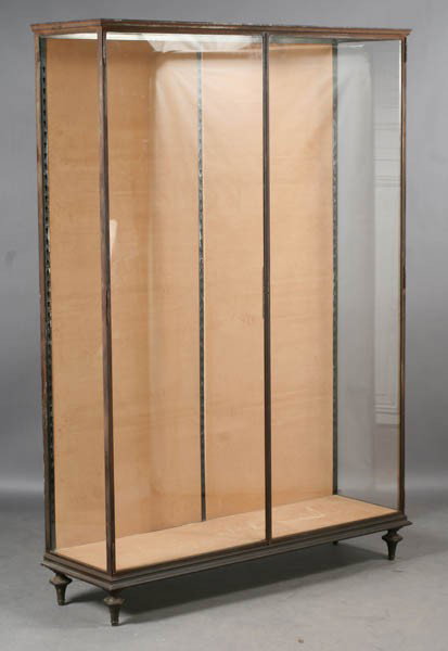 ANTIQUE METAL VITRINE 2 GLASS FRONT DOORS: A good antique steel vitrine having a molded cornice over two glass front doors raised on turned feet circa 1910. Ht: 78.5" Width: 55" Depth: 17.5"