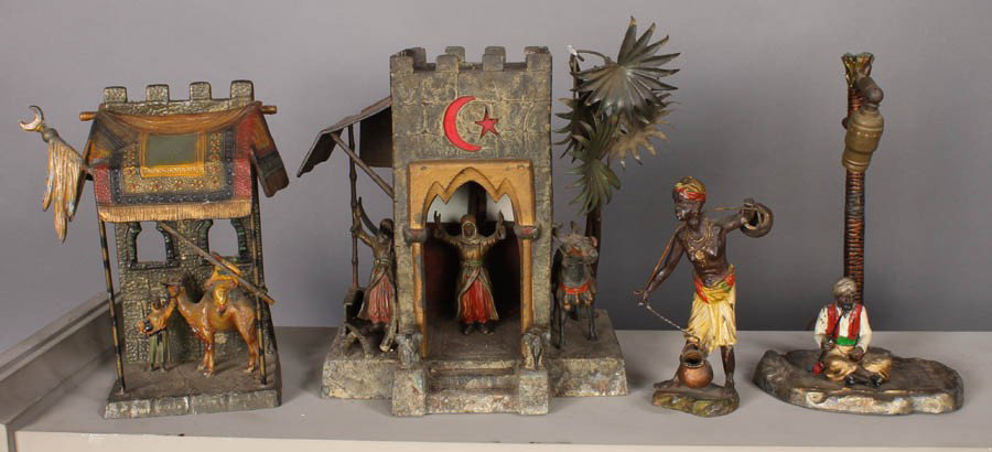 4 POLYCHROMED VIENNA BRONZES LAMP ARAB BOY CAMEL: A grouping of four polychromed Vienna bronzes including and electrified lamp, a young Arab boy, and a tent with a camel circa 1900. The lamp which depicts a shrine with two men and a donkey measures: 