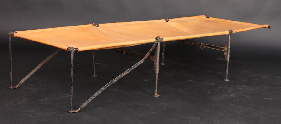 ANTIQUE FOLDING LEATHER IRON CAMPAIGN BED: Antique folding campaign bed with wrought iron frame and newer leather circa 1900. Ht: 14" Width: 24" Depth: 72"