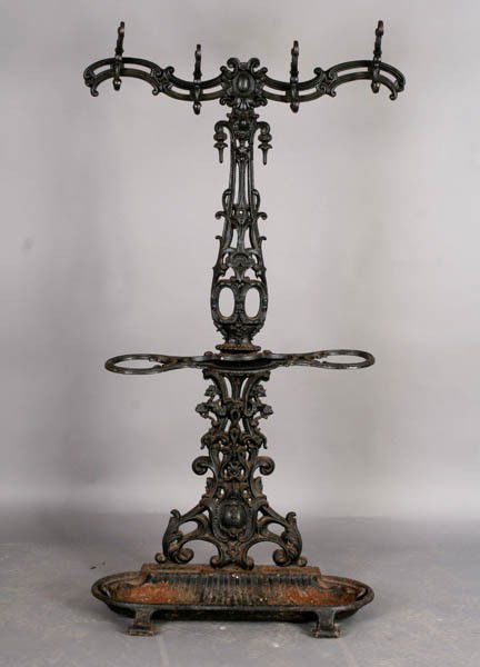 ANTIQUE CAST IRON HALL RACK ATTR. COLEBROOKDALE: Antique cast iron hall rack attributed to Colebrookdale having ornate hooks and shell form basin circa 1910. Ht: 61" Width: 33" Depth: 14.5"