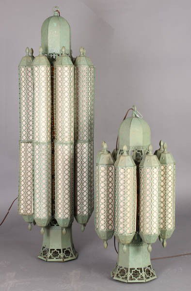 PAIR DAVID HICKS INSPIRED MOORISH PENDANT LAMPS: A pair of David Hicks inspired moorish Art Deco tin pendant lamps circa 1940. Smaller lamp measures: 35" x 16" x 16". You may bid on smaller quantity of this lot by contacting the auction house direct