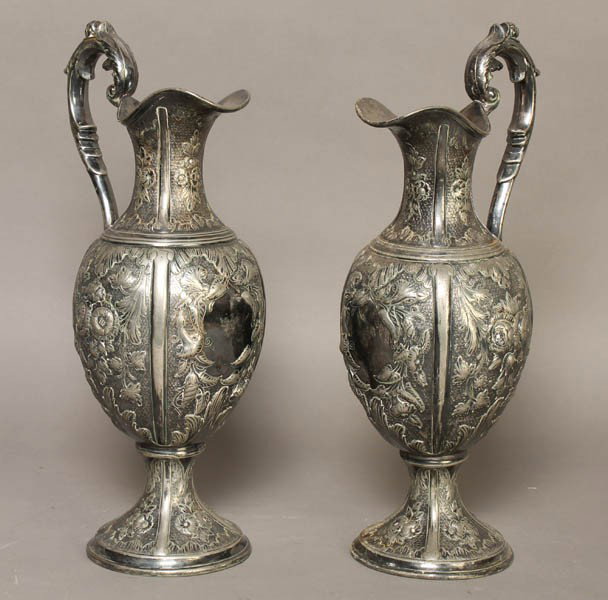 PAIR SILVERPLATE EWERS FOLIATE DECORATION: A pair of silverplate ewers having foliate decoration. Ht: 14.5"