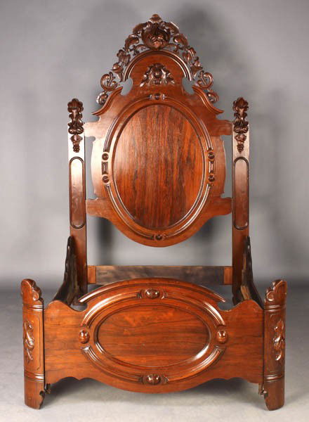 Beautifully carved rosewood mid Victorian bed: Beautifully carved rosewood mid Victorian bed having a high headboard with foliate embellishments circa 1860. With matching carved side rails and footboard. Dimensions: Ht: 80" Width: 54" Depth: 76"