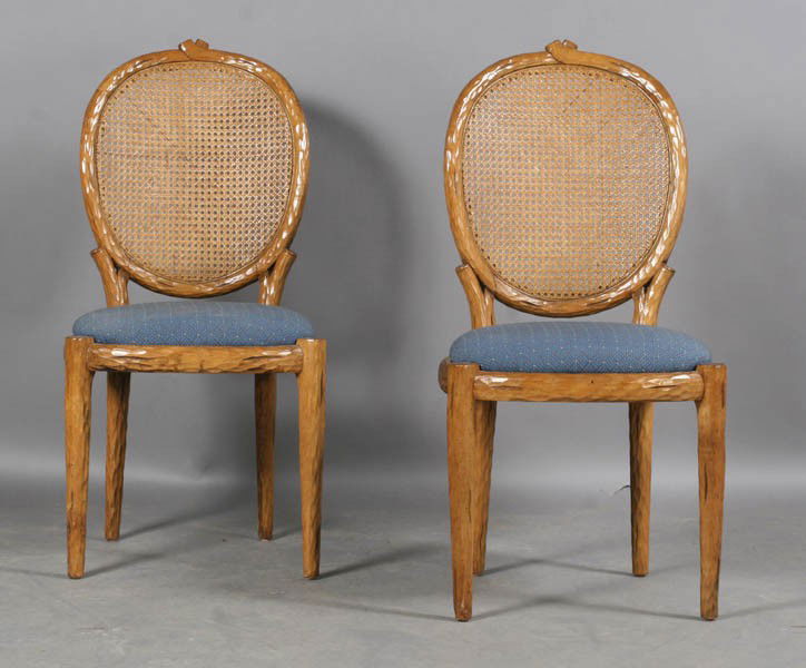 PAIR CARVED WOOD FAUX BOIS SIDE CHAIRS CANED: A pair of Continental carved wood faux bois side chairs having caned backs and upholstered seats supported on tapered legs. Ht: 38.5" Width: 18.5" Depth: 16"