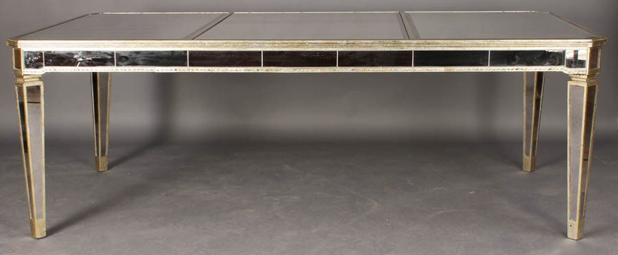 GILTWOOD DINING TABLE MIRRORED SIDES TOP ANGLED: A giltwood dining table having mirrored sides, and top with angled tapered legs circa 1960. Ht: 30" Width: 86" Depth: 46"
