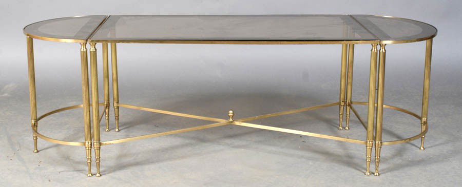 BRONZE DIRECTOIRE STYLE SMOKED GLASS COFFEE TABLE: A bronze Directoire style three-part coffee table having inset smoked glass with banding and D-shaped ends on fluted legs with X-stretcher. Circa 1970. Ht: 17" Width: 54" Depth: 19"