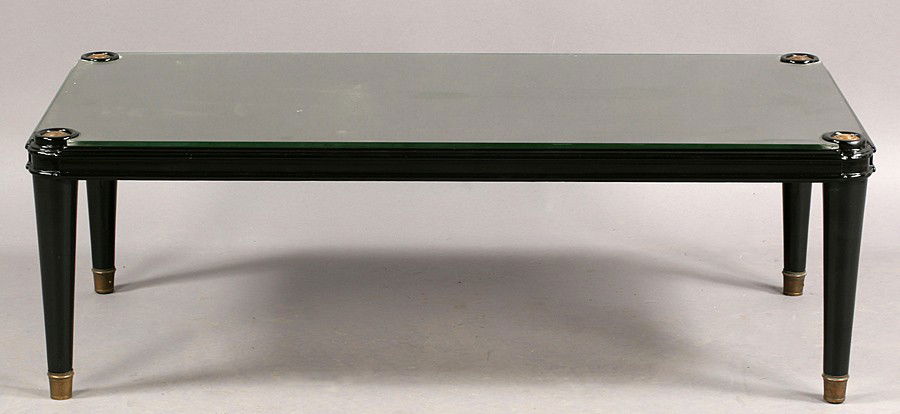 Andre Arbus style ebonized coffee table: Andre Arbus style ebonized coffee table with molded edge, turned and tapered legs with brass roundels and caps. Dimensions: Ht: 14" Width: 43" Depth: 21"