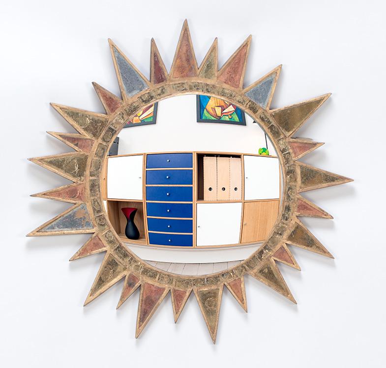 Glass and resin sunburst mirror in the manner of Line Vautrin haing three colors of glass. Ht:: Glass and resin sunburst mirror in the manner of Line Vautrin haing three colors of glass. Ht: 20.75"