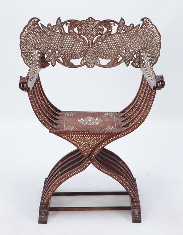A SYRIAN CHAIR WITH MOTHER OF PEARL AND FACES: A Syrian chair with elaborate mother of pearl inlay with arms that terminate into faces. Ht: 37.5" Wd: 29.5" Dpth: 20.75" Seat: 17.75"