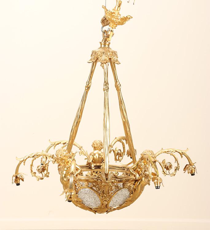 BRONZE AND CRYSTAL LOUIS XV STYLE CHANDELIER HAVING CHERUB AND RAMS HEAD MOUNTS.: Bronze and crystal Louis XV style chandelier having cherub and rams head mounts. Ht: 41.5" Dia: 35.5"