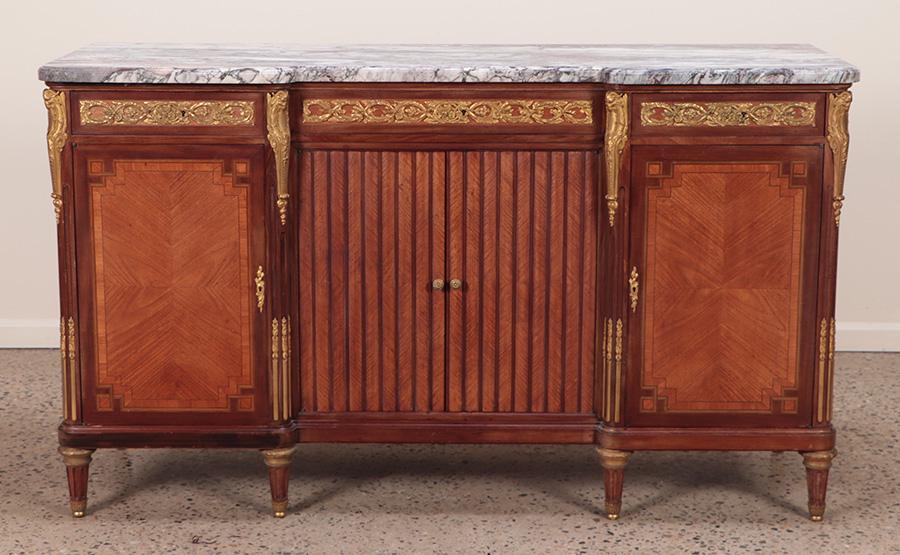FRENCH BRONZE MOUNTED MARBLE TOP SIDEBOARD IN THE LOUIS XVI STYLE HAVING FOUR DOORS C 1910.: French bronze mounted marble top sideboard in the Louis XVI style having four doors C 1910. Ht: 40" Wd: 69" Dpth: 24"