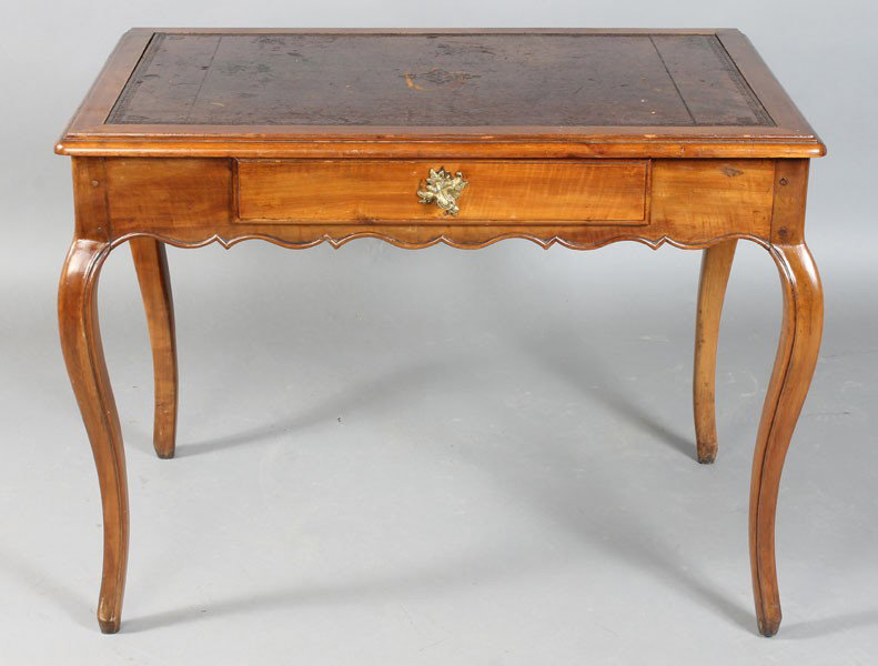 ANTIQUE FRENCH PROVINCIAL WRITING DESK TABLE: A French Provincial writing desk having an inset leather top over a single drawer and scalloped apron supported on cabriole legs. Circa 1850. Ht: 28" Width: 38" Depth: 25"