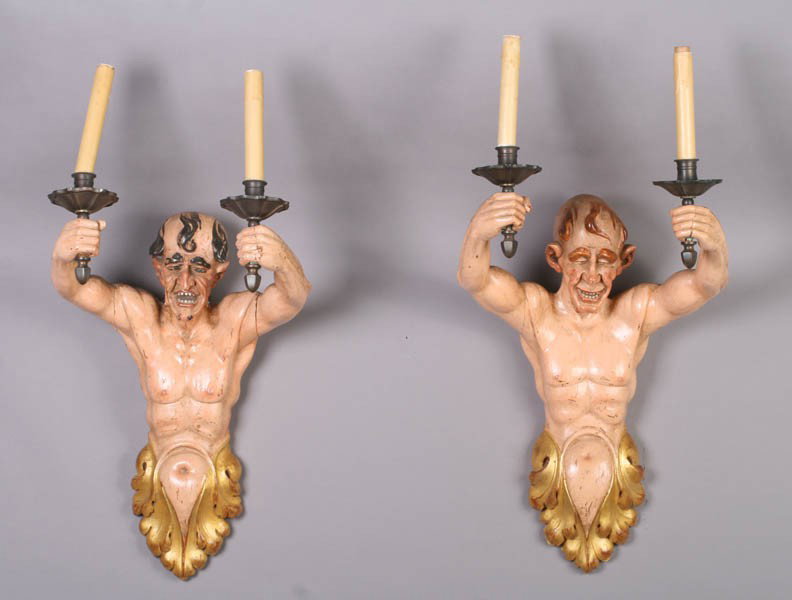 PR ANTIQUE CARVED FIGURAL POLYCHROME SCONCES: Pair of turn of the century carved and polychromed wood figural sconces, each figure with upraised arms and highly detailed face. Ht: 30" Width: 15" Depth: 13"