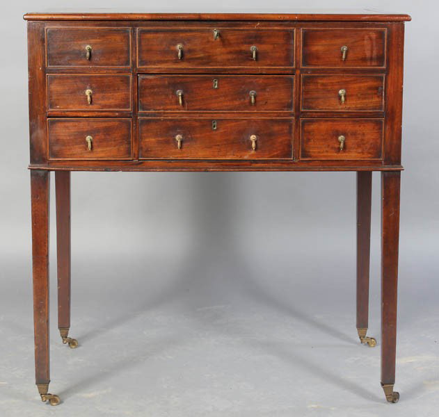 ANTIQUE GEORGE III STYLE ENGLISH DRESSING TABLE: Nineteenth century George III style English mahogany dressing table, the hinged top opening to reveal a fitted interior. The case having three faux drawers and five functional drawers. Ht: 32" Width: 