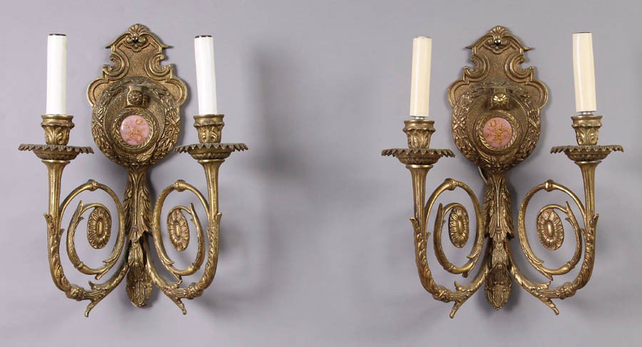 PR WALL SCONCES LIGHTING PORCELAIN INSERT: Pair of double-armed wall sconces each having a central porcelain floral insert and classical embellishments. Ht: 12" Width: 10" Depth: 15"