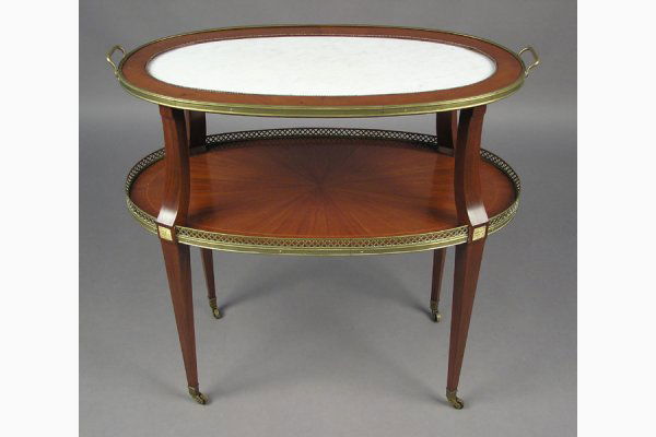 REGENCY STYLE FRENCH TWO-TIER SERVING CART SERVER DESS: REGENCY STYLE MAHOGANY TWO-TIER SERVING CART CIRCA 1930. The top section having a white marble top and the bottom wood shelf having a starburst design. Both shelves being bound by bronze H: 29" W: 31"