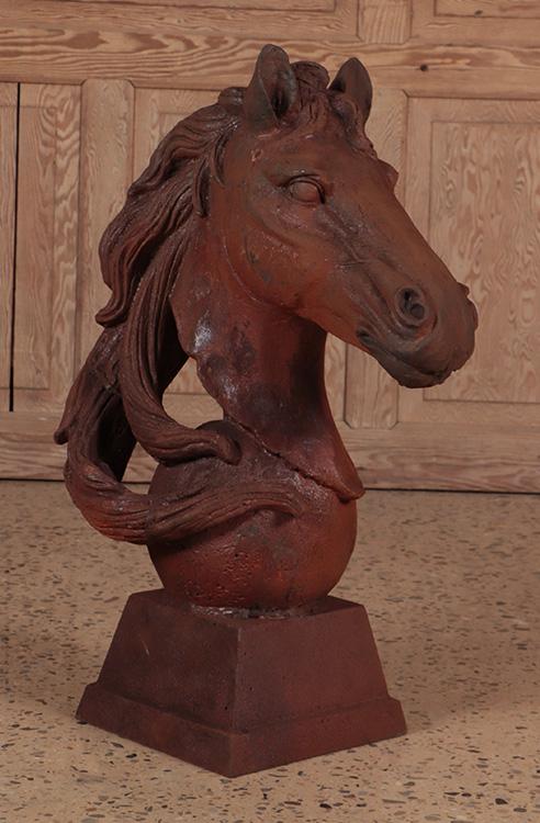 A CAST IRON GARDEN STATUE OF A HORSE HEAD WITH MANE RESTING ON AN ANGLED PLINTH SUPPORTED SPHERE. (1 of 6)